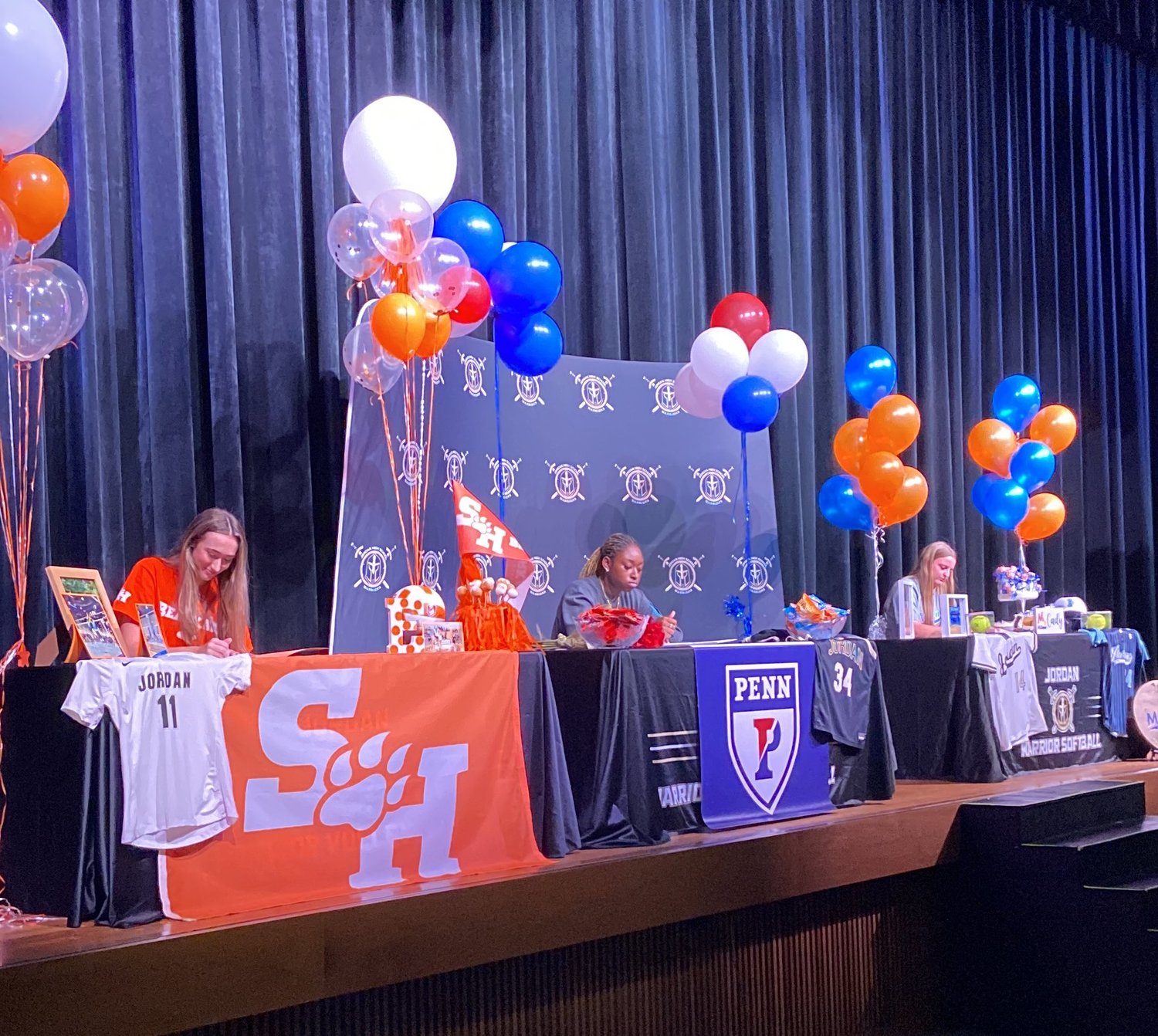 Ella Folse, Tobi Ademuwagun and Cady Bowyer sign their national letter of intents during Jordan's signing day ceremony.
